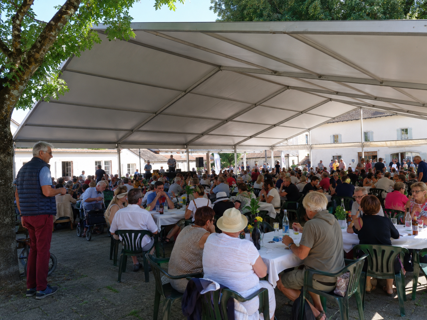 Carpa modular de gran formato con mesas de banquete y comensales en un evento popular